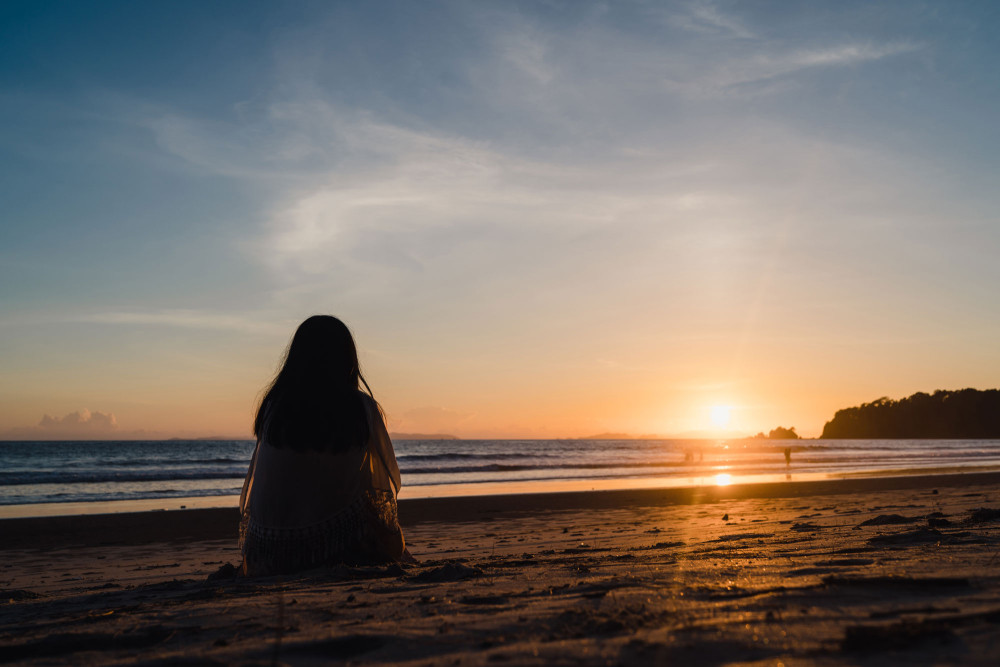 person sitting on beach